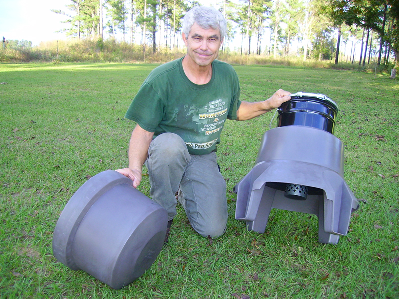 Wildlife biologist Jim Evans with poly pail quail feeders